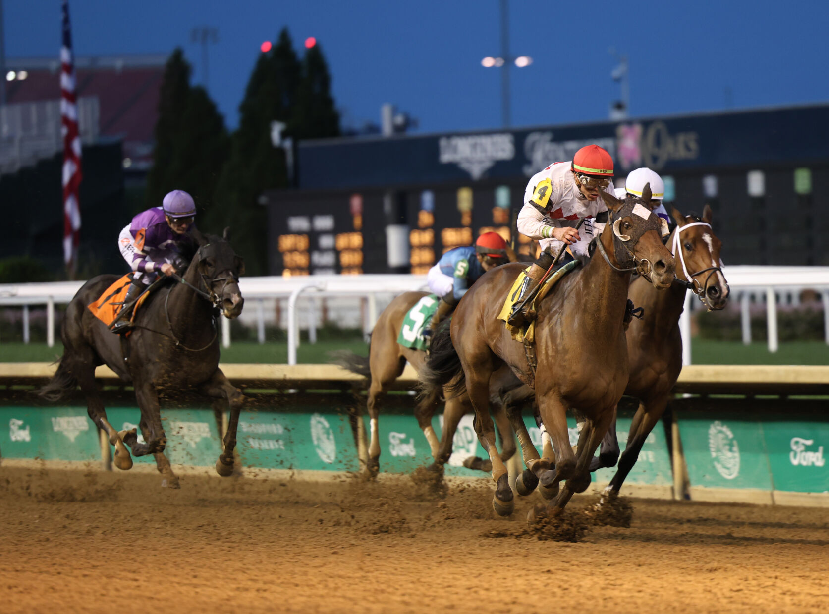 Horses close during night race.JPG